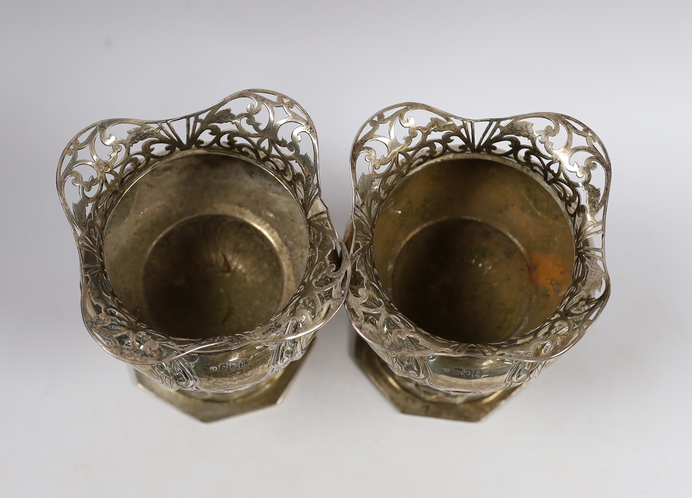 A pair of Edwardian silver pedestal vases, with pierced borders, Charles Edwards, London, 1903 height 15.8cm, 19.8oz.